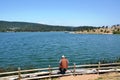 The man fishing at the lakeside