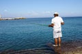 Man fishing in the Mandraki port in Rhodes