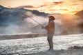 Man fishing at morning sunrise in a mountain river in Alaska, USA. Royalty Free Stock Photo