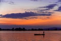 Man fishing from a non-motor boat on the Danube at sunset Royalty Free Stock Photo