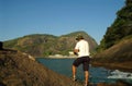 Man fishing off coast Royalty Free Stock Photo