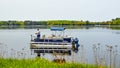 Man Fishing off a Pontoon Boat on Lake