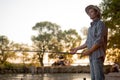 Man fishing outside in evening on lake in summer, enjoy spending time in nature, side view portrait of male in casual Royalty Free Stock Photo