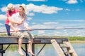 Man with a fishing pole and his beloved woman on a wooden pier o Royalty Free Stock Photo