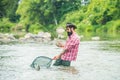 Man fishing and relaxing while enjoying hobby. Fish on the hook. Fisherman and trout. Summer holidays and people concept