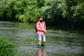 Man fishing and relaxing while enjoying hobby. A fisherman with fishing rod on the river. Fisherman and trout. Holding