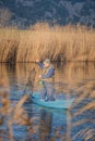 Man fishing in river, capturing fish with a net from the boat in Metkovic, Croatia Royalty Free Stock Photo