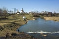 Man fishing in river Kamenka in Suzdal, nature of middle Russia, old Russian church in sunny day in spring middle april Royalty Free Stock Photo