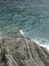 Man fishing from rock