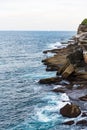 Man fishing on the rocks along the Bondi to Coogee coastal walk in Sydney, Australia Royalty Free Stock Photo