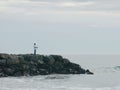 Man fishing on a rocky pier in Newport Beach, California