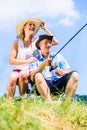 Man with fishing rod angling at lake enjoying hug Royalty Free Stock Photo