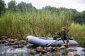 Man fishing rod on the river on a rubber boat. Hobby. Royalty Free Stock Photo