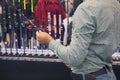 Man with a fishing rod in a fishing shop