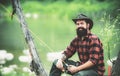 Man fishing. Sitting alone during the fishing process near the lake. Hobby and sport activity. Fisherman with rod and