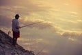 Man fishing in the sky reflection