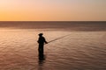 Man fishing at sunset, Tombeau Bay, Mauritius Royalty Free Stock Photo