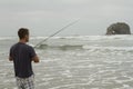 Man fishing in the surf on Rockaway beach Royalty Free Stock Photo