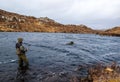 Man fishing for trout and salmon in a Scottish loch