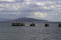 A man is fishing on the wreckage of an old pier