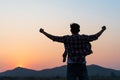 Man with fist in the air during sunset sunrise mountain in background. Stand strong. Feeling motivated, freedom, strength and Royalty Free Stock Photo