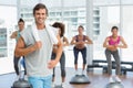 Man with fit people performing step aerobics exercise Royalty Free Stock Photo