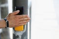 Male hand presses a button on a pedestrian crossing