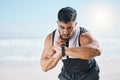 Man, fitness and checking watch for pulse, heart rate or performance on break after workout on the beach. Fit, active Royalty Free Stock Photo