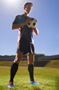 Man, fitness and confident soccer player on field, athlete and competitive for match or game. Male person, serious and Royalty Free Stock Photo