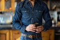 man in fitted denim shirt, jeans, sipping espresso, caf