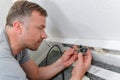 Man fitting electrical socket in skirting board Royalty Free Stock Photo