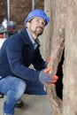 man fitting insulation into walls Royalty Free Stock Photo