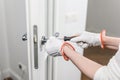 A man fixes a door with a screwdriver. Door lock repair Royalty Free Stock Photo