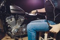 Man fixing bike. Confident young man repairing motorcycle near his garage. barometer