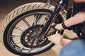 Man fixing bike. Confident young man repairing motorcycle near his garage.