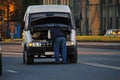 Man fixing a car on the road Royalty Free Stock Photo