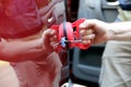 Man fixing car dent by himself Royalty Free Stock Photo