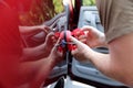 Man fixing car dent by himself Royalty Free Stock Photo