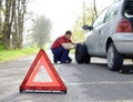 Man fixing a car problem after vehicle breakdown on the road Royalty Free Stock Photo