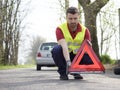 Man fixing a car problem after vehicle breakdown Royalty Free Stock Photo