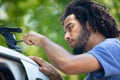 man fixing car roof rack outdoors Royalty Free Stock Photo