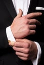 Man fixing cufflinks. Gentleman in black suit. Elegant and stylish clothes. Male fashion. Business look. Royalty Free Stock Photo