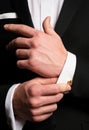 Man fixing cufflinks. Gentleman in black suit. Elegant and stylish clothes. Male fashion. Business look. Royalty Free Stock Photo