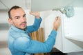 man fixing cupboard door Royalty Free Stock Photo