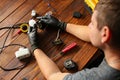 Man fixing desk lamp wires top view. Electrician repairing lights. Technician service workplace concept. Tools and Royalty Free Stock Photo