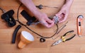 Man fixing desk lamp wires top view Royalty Free Stock Photo