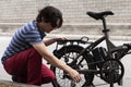 Man fixing electric bike on the side of the road