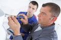 Man fixing electronic circuits in service center