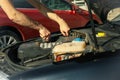 Man fixing engine Car inspection. Work of mechanic