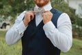 Man fixing his bow tie. Man groom in wedding suit with a bow tie. Close-up Royalty Free Stock Photo